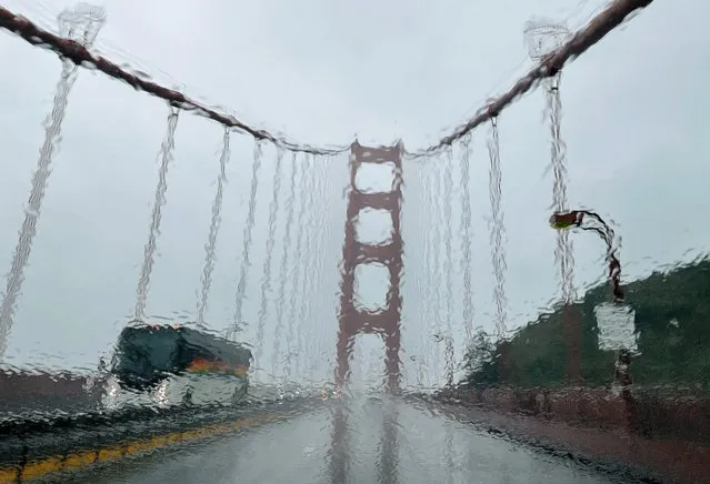The Golden Gate Bridge is seen through a rain covered windshield on January 04, 2023 in San Francisco, California. A massive storm is hitting Northern California bringing flooding rains and damaging wind (Photo by Justin Sullivan/Getty Images)