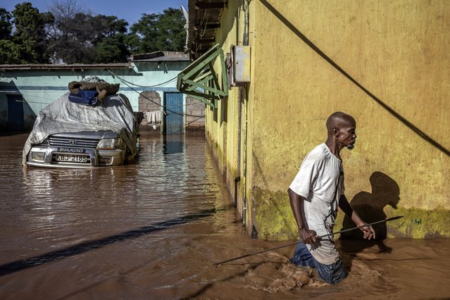 Boya Ali Karani, 64, wades through flood waters in the area where he used to live after being displaced by floods at an inundated area in Garissa, on May 9, 2024. Kenya is grappling with one of its worst floods in recent history, the latest in a string of weather catastrophes, following weeks of extreme rainfall scientists have linked to a changing climate. At least 257 people have been killed and more than 55,000 households have been displaced as murky waters submerge entire villages, destroy roads and inundate dams. (Photo by Luis Tato/AFP Photo)