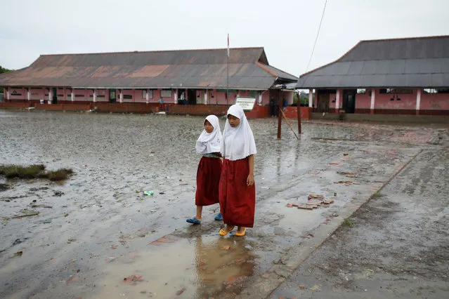 Students walk in the yard of the Pantai Bahagia Elementary School, before tide comes in, in Bekasi, West Java province, Indonesia, February 1, 2018. (Photo by Darren Whiteside/Reuters)