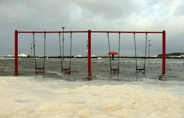 Waves flood a children's play park in Portstewart in northern Ireland December 10, 2014. (Photo by Cathal McNaughton/Reuters)