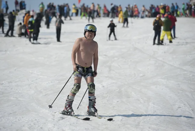 A man striped to the waist during the Naked Pig Skiing Carnival at the Yabuli Ski Resort on March 24, 2018 in Harbin of Heilongjiang Province, northeast China. (Photo by Tao Zhang/Getty Images)
