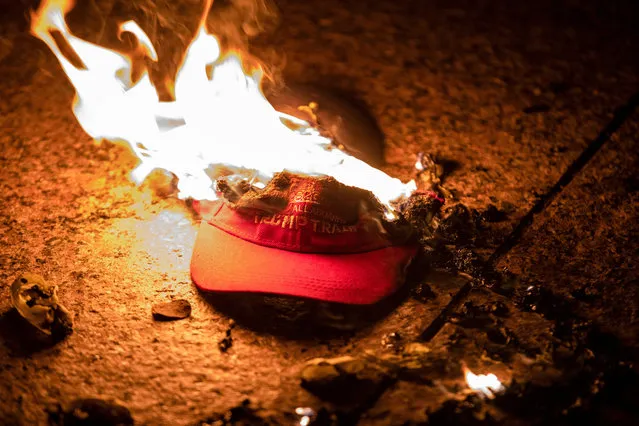 Members of an Antifa group burn a Trump Train hat prior to clashes with a group of Proud Boys following the “Million MAGA March” on November 14, 2020 in Washington, DC. Various pro-Trump groups gathered in DC today for the “Million MAGA March” to protest the results of the 2020 presidential election. (Photo by Samuel Corum/Getty Images)