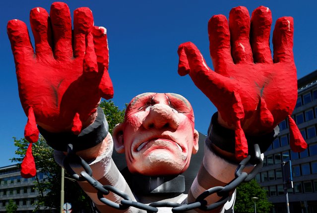 An installation depicting Russian President Vladimir Putin stands in front of the Peace Palace as protesters call for Putin to go to jail instead of another term in the Kremlin, on the day of his swearing-in for a new six-year term as president, in The Hague, Netherlands, on May 7, 2024. (Photo by Piroschka van de Wouw/Reuters)