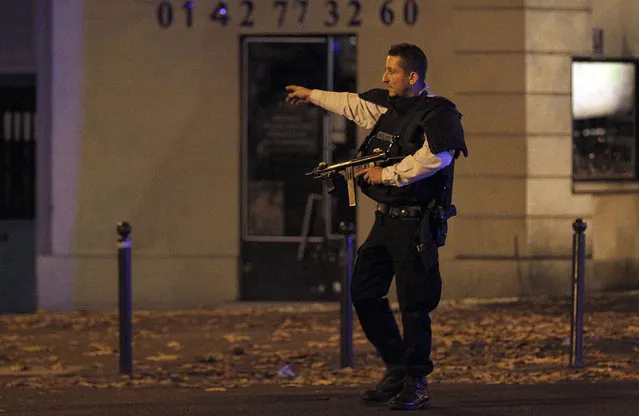 Police survey the area of Boulevard Baumarchais after an attack in the French capital on November 13, 2015 in Paris, France. At least 18 people were killed in a series of gun attacks across Paris, as well as explosions outside the national stadium where France was hosting Germany. (Photo by Thierry Chesnot/Getty Images)