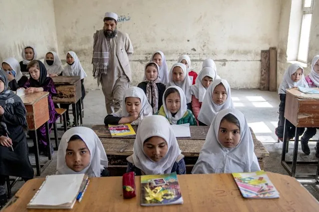 Girls attend class on the first day of the new school year, in Kabul, Afghanistan, on Saturday, March 25, 2023. The new Afghan educational year started, but high school remained closed for girls for the second year after Taliban returned to power in 2021. (Photo by Ebrahim Noroozi/AP Photo)