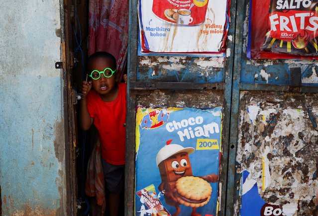 A child watches as a crowd walks past during a nationwide youth-led protest over frequent power outages and water shortages, in Antananarivo, Madagascar, on October 6, 2025. (Photo by Siphiwe Sibeko/Reuters)