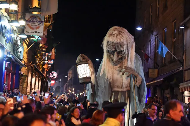 A member of street performance troupe Macnas participates in their 30th anniversary during the Halloween parade called Savage Grace in Galway, Ireland October 30, 2016. (Photo by Clodagh Kilcoyne/Reuters)