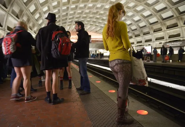 Participants in the No Pants Subway Ride DC, waits for a train at the Gallery Place – Chinatown stop on January 11, 2015 in Washington, DC. (Photo by Mandel Ngan/AFP Photo)