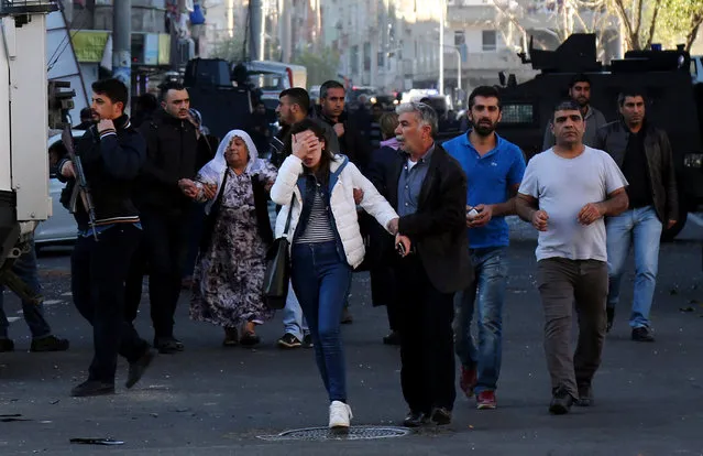 People run away after a blast in the Kurdish-dominated southeastern city of Diyarbakir, Turkey, November 4, 2016. (Photo by Sertac Kayar/Reuters)