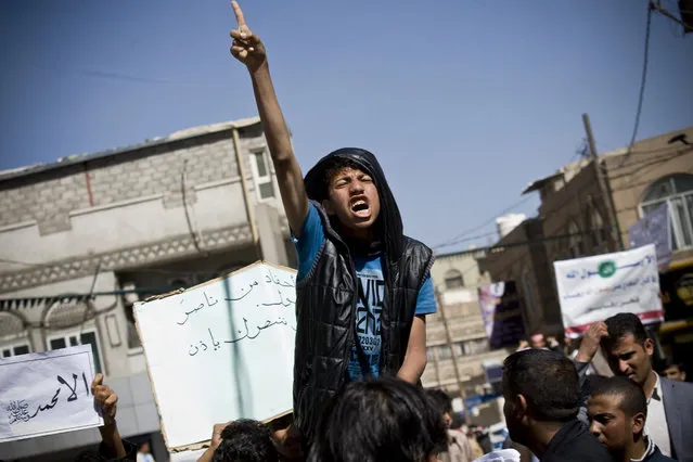 A Yemeni youth chants slogans during a protest against caricatures published in French magazine Charlie Hebdo in front of the French Embassy in Sanaa, Yemen, Saturday, January 17, 2015. (Photo by Hani Mohammed/AP Photo)