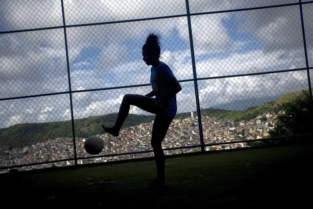 Jessica do Vale controls a ball during a street soccer training program run by the Street Child United Brazil non-governmental organization, at the Complexo da Penha favela, in Rio de Janeiro, Brazil, Saturday, April 29, 2023. Girls are challenging the male-dominated sport stereotype with the support of trainers from the community, being taught more than just soccer but also personal development. (Photo by Bruna Prado/AP Photo)
