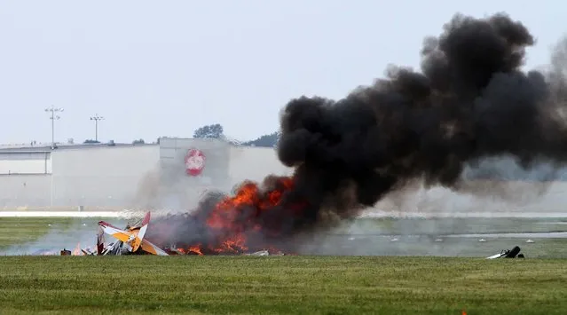 The plane burns after the crash. (Photo by Darin Pope/Dayton Daily News)