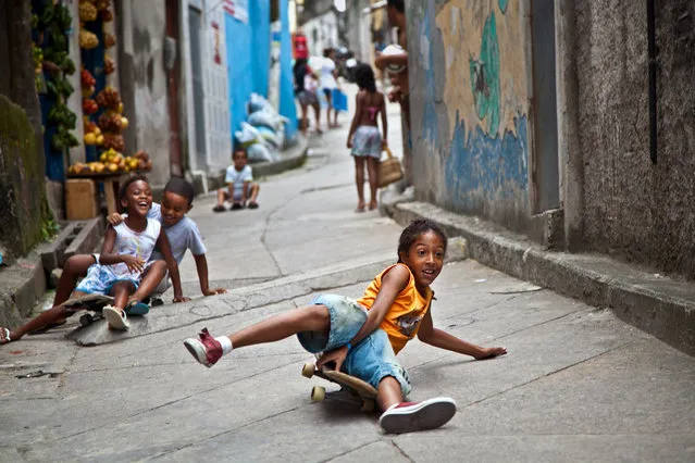 “Enjoying life”. These kids enjoyed free saturday by playing on narrow streets of favela Vidigal. They loved the camera and seeing themselves in pictures. We hade so much fun together! Location: Vidigal, Rio de Janeiro, Brazil. (Photo and caption by Anna Karatvuo/National Geographic Traveler Photo Contest)