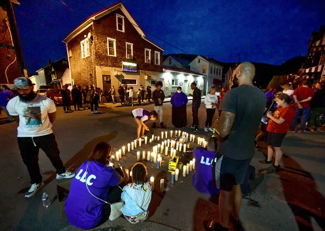 Family and friends of Caleb Beppler, who was fatally shot on Saturday, June 10, 2023, gather for a candlelight vigil at the scene on the 300 block of Second Avenue in the Cambria City section of Johnstown on Sunday, June 11, 2023. (Photo by Thomas Slusser/AP Photo)