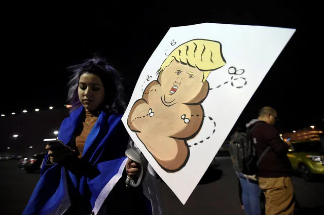 A demonstrator displays her placard during a protest march against the election of Republican Donald Trump as President of the United States in Las Vegas, Nevada, U.S. November 12, 2016. (Photo by David Becker/Reuters)