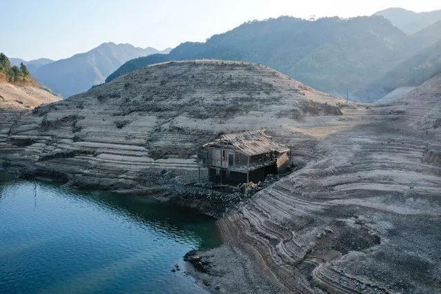 Drought caused the water level to drop in part of a reservoir to reveal the remains of villages where people used to live in Ningbo, Zhejiang province, China, February 21, 2021. (Photo by Costfoto/Barcroft Media via Getty Images)