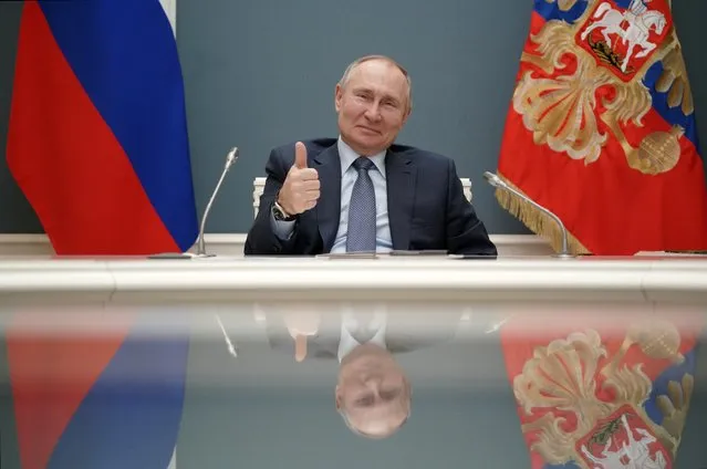 Russian President Vladimir Putin shows a thumbs-up as he takes part in a ceremony with his Turkish counterpart Recep Tayyip Erdogan via video conference of remotely inaugurating the construction of a third nuclear reactor of Akkuyu power plant in southern Turkey, in Moscow, Russia, Wednesday, March 10, 2021. The presidents of Turkey and Russia have remotely inaugurated the construction of a third nuclear reactor of Akkuyu power plant in southern Turkey, vowing to continue their close cooperation. (Photo by Alexei Druzhinin, Sputnik, Kremlin Pool Photo via AP Photo)
