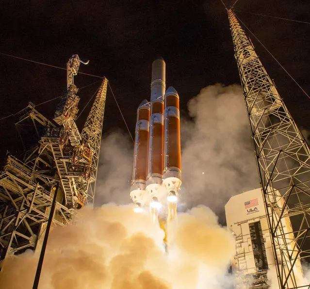 A handout photo made available by the NASA shows the United Launch Alliance Delta IV Heavy rocket launches NASA's Parker Solar Probe to touch the Sun, from Launch Complex 37 at Cape Canaveral Air Force Station, Florida, USA, 12 August 2018. Parker Solar Probe is humanity’s first-ever mission into a part of the Sun’s atmosphere called the corona. Here it will directly explore solar processes that are key to understanding and forecasting space weather events that can impact life on Earth. (Photo by Bill Ingalls/EPA-EFE/NASA)