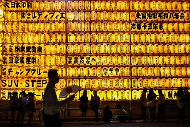 Visitors enjoy the display of lanterns during the annual Mitama Festival at Yasukuni Shrine in Tokyo, Japan on July 13, 2023. Over 20,000 lanterns are displayed along the entrance and inside the shrine to help spirits find their way during the annual celebration for the spirits of ancestors. The festival runs until July 16. (Photo by Rodrigo Reyes Marin/ZUMA Press Wire/Alamy Live News)