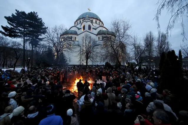 Believers burn dried oak branches, which symbolizes the Yule log, on Orthodox Christmas Eve in front of the St. Sava temple in Belgrade, Serbia, January 6, 2016. (Photo by Marko Djurica/Reuters)