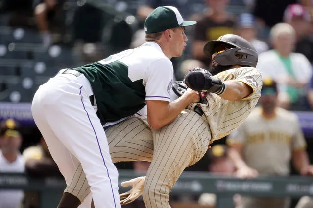 Colorado Rockies relief pitcher Brent Suter, left, tags out San Diego Padres' Fernando Tatis Jr. as he tries to advance from third to home during the seventh inning of a baseball game Wednesday, August 2, 2023, in Denver. (Photo by David Zalubowski/AP Photo)