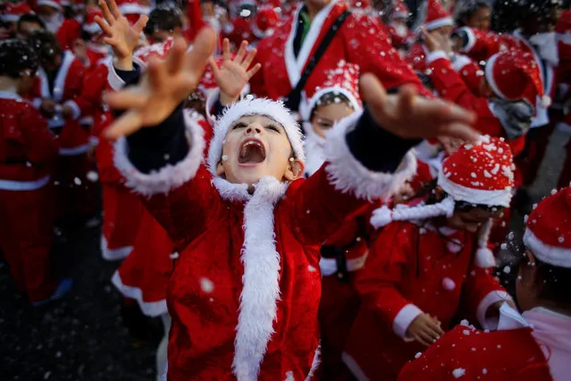 Children dressed as Santa Claus participe in a parade held to collect food for the needy, in Lisbon, Portugal December 12, 2016. (Photo by Rafael Marchante/Reuters)
