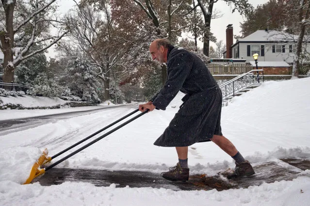 Richard Burst clears snow from his driveway Thursday, November 15, 2018 in St. Louis. “All I really need to accomplish are two lanes for my car”, he said. Much of the region had at least 4 inches of snow and forecasters expect about 1 inch or 2 inches more will fall by the time it tapers off around noon Thursday. (Photo by Robert Cohen /St. Louis Post-Dispatch via AP Photo)