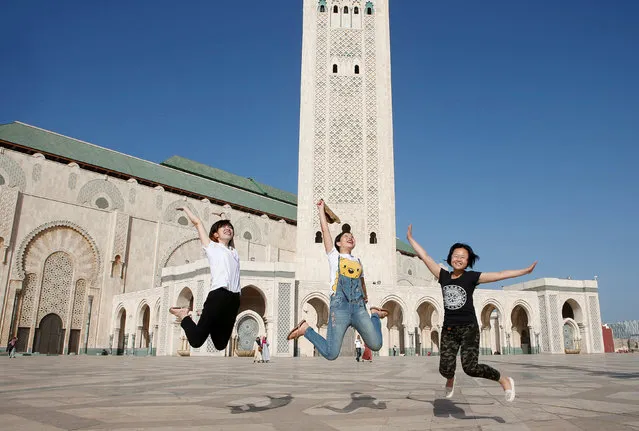 Chinese tourists jump as they pose for photographs at the esplanade of the Hassan II Mosque in Casablanca, Morocco, October 6, 2016. (Photo by Youssef Boudlal/Reuters)