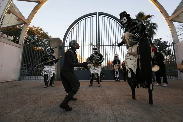 Members of the North Side Skull & Bone Gang dance in front of the Louis Armstrong park during the wake up call for Mardi Gras, Tuesday, February 9, 2016, in New Orleans. (Photo by Brynn Anderson/AP Photo)