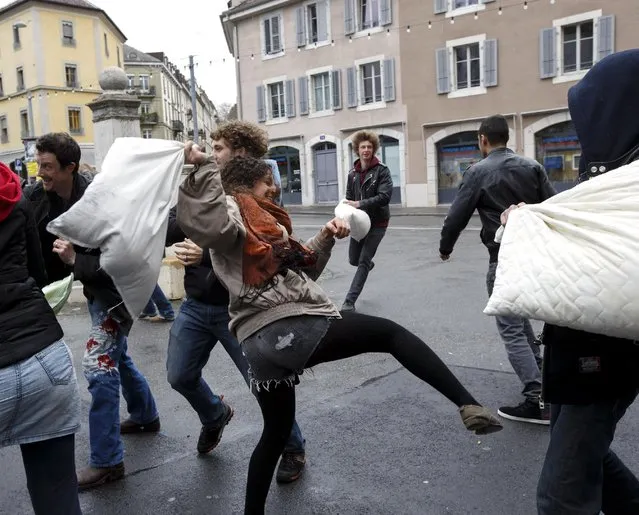Young people fight for  fun with their pillows, during the International Pillow Fight Day at the Place des Grottes, in Geneva, Switzerland, Saturday, April 4, 2015. The annual International Pillow Fight Day takes place in hundreds of cities around the world. (Photo by Salvatore Di Nolfi/AP Photo/Keystone)