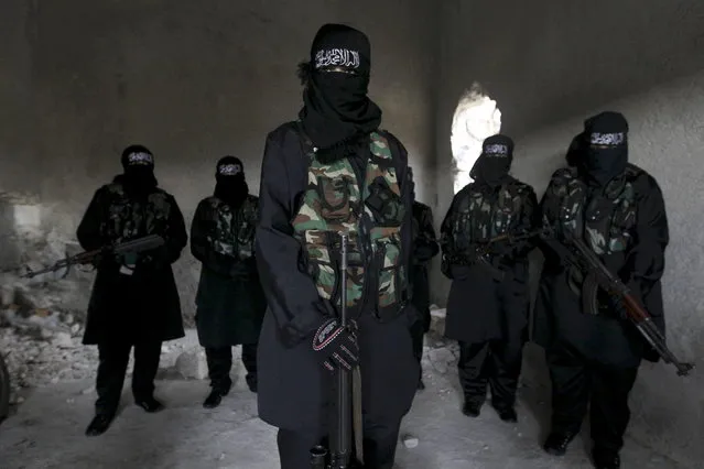 Women, who are part of “Sawt al-Haq” (Voice of Rights), stand with their weapons as they undergo military training in Aleppo February 17, 2013. (Photo by Muzaffar Salman/Reuters)
