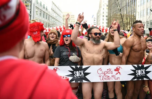 Participants in this year's Cupid's Undie Run wait outside in the cold to start their race on I Street between 17th and 18th streets in Washington, D.C., February 12, 2016. The one-mile (or less) run, which requires attendees to show up in their “bedroom-best” is intended to raise money for The Children's Tumor Foundation. (Photo by Astrid Riecken/The Washington Post)