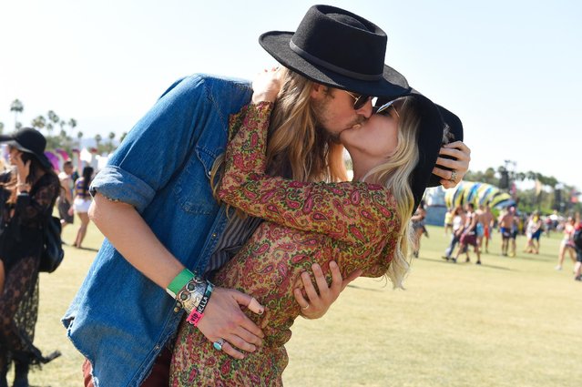Two concert goers kiss at the 2015 Coachella Music and Arts Festival on Saturday, April 11, 2015, in Indio, Calif. (Photo by Scott Roth/Invision/AP Photo)