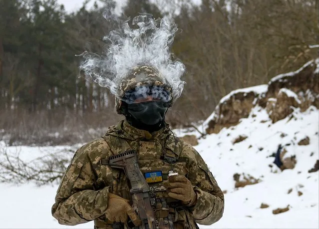 A member of the Siberian Battalion of the Ukraine's Armed Forces International Legion smokes a disposable vape during military exercises, amid Russia's attack on Ukraine, at an undisclosed location in Kyiv region, Ukraine on December 13, 2023. (Photo by Valentyn Ogirenko/Reuters)