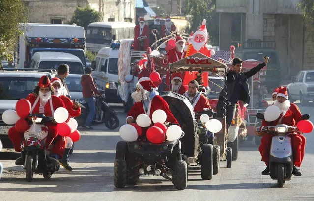 Lebanese Christians dressed as Santa Claus celebrate Christmas in Jiyeh village, south of Beirut December 24, 2013. (Photo by Sharif Karim/Reuters)
