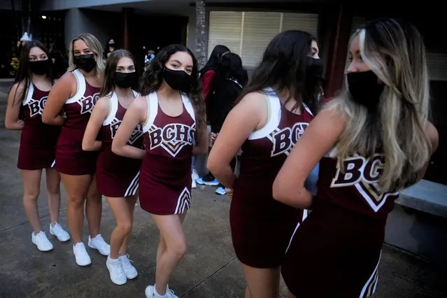 School cheerleaders wearing protective masks pose for a photo as fellow students arrive for classes on the first day of school in Miami-Dade County at Barbara Goleman Senior High School, in Miami, Florida, August 23, 2021. (Photo by Marco Bello/Reuters)