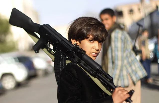A Yemeni boy holding a weapon, poses for a picture during a demonstration against an arms embargo imposed by the U.N. Security Council on Houthi leaders, in Sanaa, Yemen, Thursday, April 16, 2015. (Photo by Hani Mohammed/AP Photo)