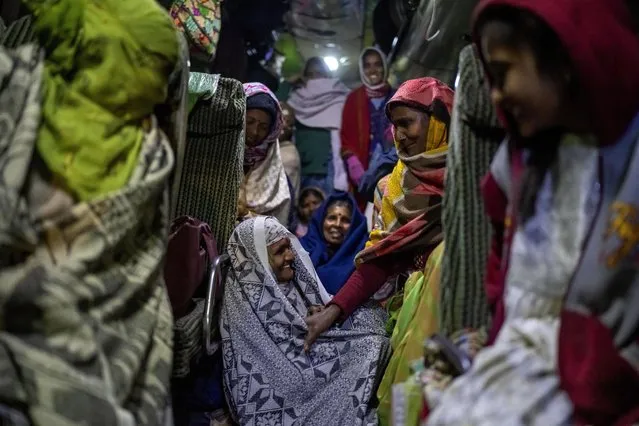 Indian pilgrims huddle inside a bus as they wait for their departure after visiting Pashupatinath temple in Kathmandu, Nepal, January 12, 2024. (Photo by Niranjan Shrestha/AP Photo)