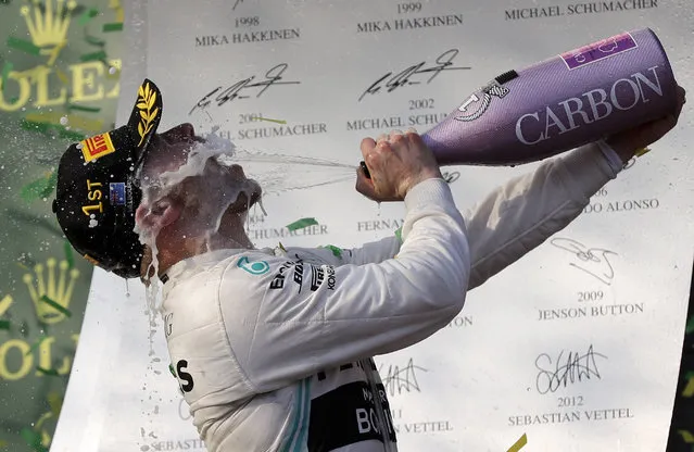 Mercedes driver Valtteri Bottas of Finland sprays himself with champagne after winning the Australian Formula 1 Grand Prix in Melbourne, Australia, Sunday, March 17, 2019. Bottas won ahead of teammate Lewis Hamilton of Britain while Red Bull driver Max Verstappen of the Netherlands placed third. (Photo by Rick Rycroft/AP Photo)