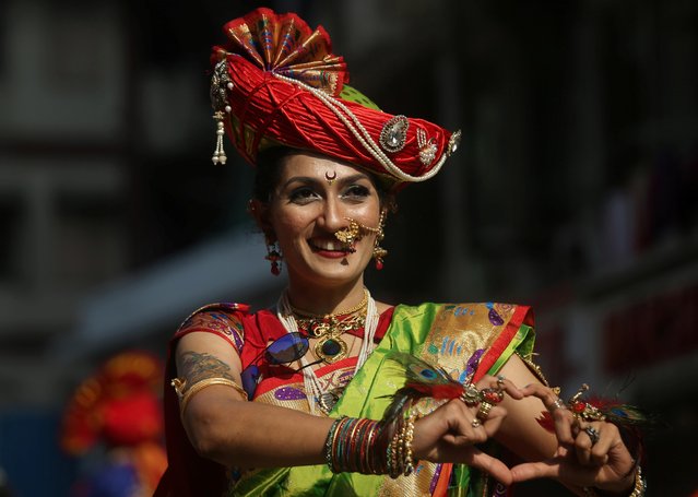A woman dressed in a traditional costume gestures as she attends celebrations to mark the Gudi Padwa festival, the beginning of the New Year for Maharashtrians, in Mumbai, April 6, 2019. (Photo by Francis Mascarenhas/Reuters)