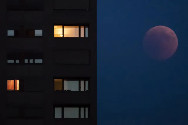 The moon turns red during a total lunar eclipse, as seen from Zurich, Switzerland, Friday, July 27, 2018. Skywatchers around much of the world are looking forward to a complete lunar eclipse that will be the longest this century. (Photo by Ennio Leanza/Keystone via AP Photo)