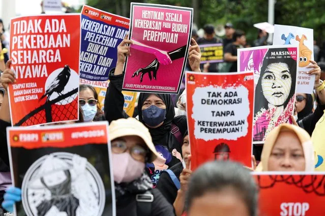 People carrying placards take part in a rally to support women's rights calling for gender equality, protest against gender discrimination and demand the impeachment of Indonesia's President Joko Widodo during International Women's Day in Jakarta, Indonesia, on March 8, 2024. (Photo by Ajeng Dinar Ulfiana/Reuters)