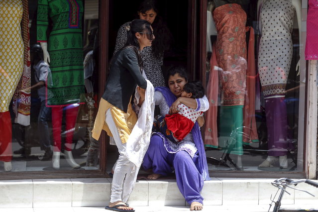 Local residents fall down as they evacuate from a shop during a fresh 7.3 earthquake, in central Kathmandu, Nepal, May 12, 2015. (Photo by Athit Perawongmetha/Reuters)