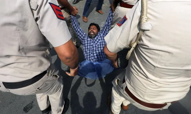 Indian security personnel detain a member of Aam Aadmi Party (AAP) during a protest against the Delhi Chief Minister Arvind Kejriwal's arrest, near Bharatiya Janta Party headquarters in New Delhi, India, 22 March 2024. Kejriwal was arrested by the Enforcement Directorate (ED) over the alleged irregularities in Delhi's liquor excise policy case on 21 March 2024. (Photo by Rajat Gupta/EPA/EFE)