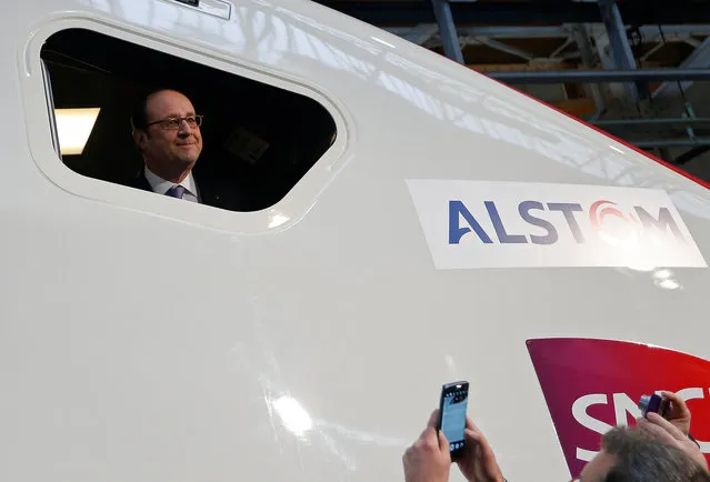 French President Francois Hollande looks from a window of the cockpit of a high-speed train TGV at the Alstom factory in Belfort, France, February 22, 2017. (Photo by Vincent Kessler/Reuters)