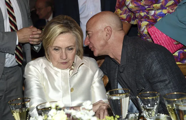 Former Secretary of State Hillary Clinton, left, and Amazon CEO Jeff Bezos chat at the Statue of Liberty Museum opening celebration at Battery Park on Wednesday, May 15, 2019, in New York. (Photo by Evan Agostini/Invision/AP Photo)