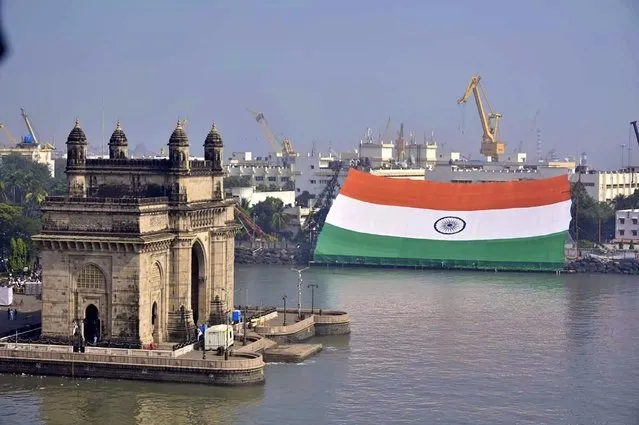 This handout photograph taken on December 4, 2021 and released by the Indian Navy shows a gigantic India's national flag exhibited by the Western Naval Command at the naval dockyard in Mumbai. (Photo by Indian Navy/AFP Photo)