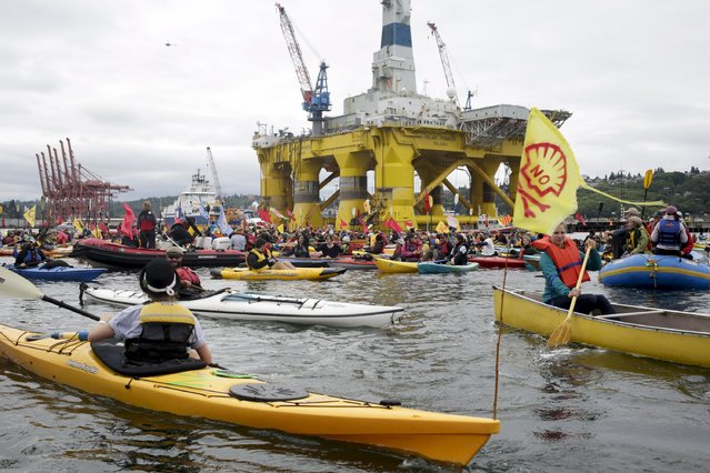 Activists protest the Shell Oil Company's drilling rig Polar Pioneer which is parked at Terminal 5 at the Port of Seattle, Washington May 16, 2015. (Photo by Jason Redmond/Reuters)