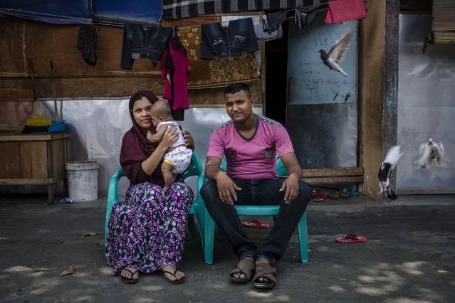 A Rohingya refugee family Pir Muhammad (21) and his wife Yurita (18) with their son, pose for photograph in front of their refugee camp on February 11, 2017 in Medan, North Sumatra, Indonesia. Pir Muhammad, have been in refugee camp for four years and are not able to legally work while waiting for registration and resettlement. (Photo by Ulet Ifansasti/Getty Images)