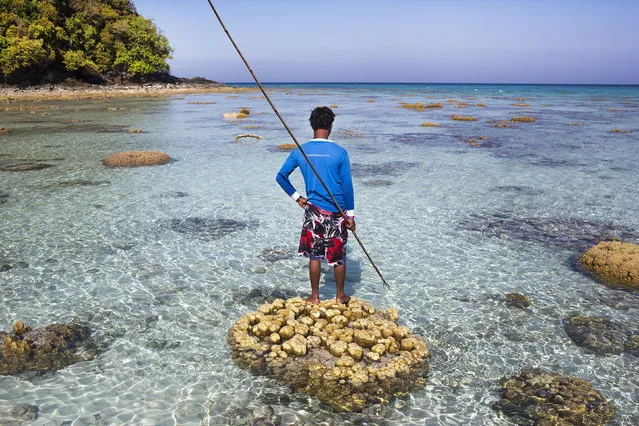 Hook, an indigenous Moken man, holds a three-pronged throwing spear and searches for fish in the waters of Ko Surin National Park. March 1, 2013 – Ko Surin, Thailand. (Photo by Taylor Weidman/zReportage via ZUMA Press)